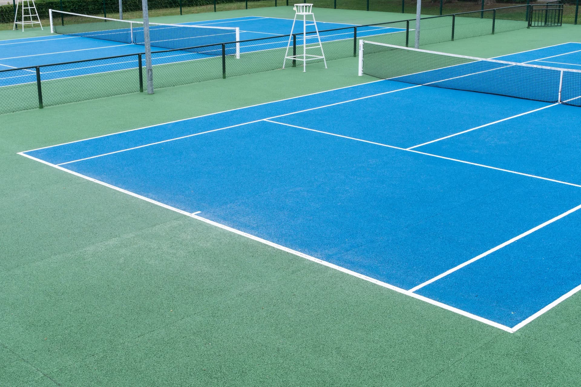 Finished regulation tennis court with acrylic surface and crisp white line striping backyard